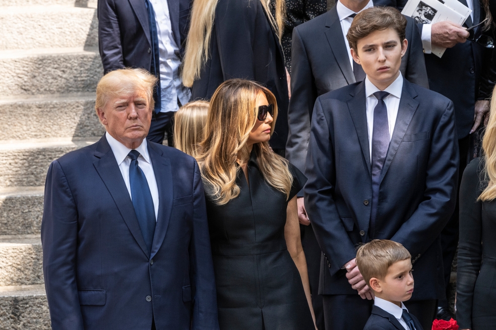 New York, NY - July 20, 2022: Former President Donald Trump, Melania Trump, Barron Trump watch as casket with body of Ivana Trump loaded into hearse at St. Vincent Ferrer Church