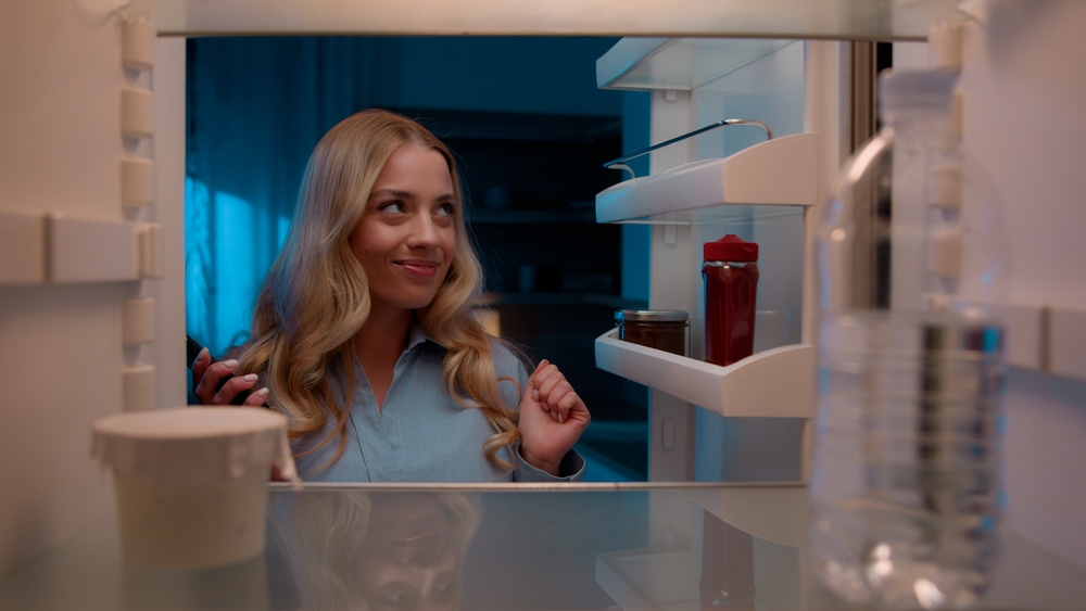 Point of view POV inside refrigerator Caucasian girl hungry woman open fridge at home kitchen look at empty shelves order food products delivery with mobile phone app online service web store shopping