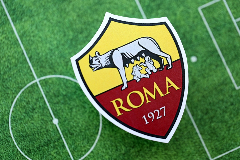 KYIV, UKRAINE - FEBRUARY 23, 2025 AS Roma football club badge lies on soccer field background banner