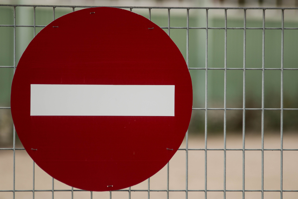 Stop, deny, do not, no entry sign, access denied/restricted on a metal fence background
