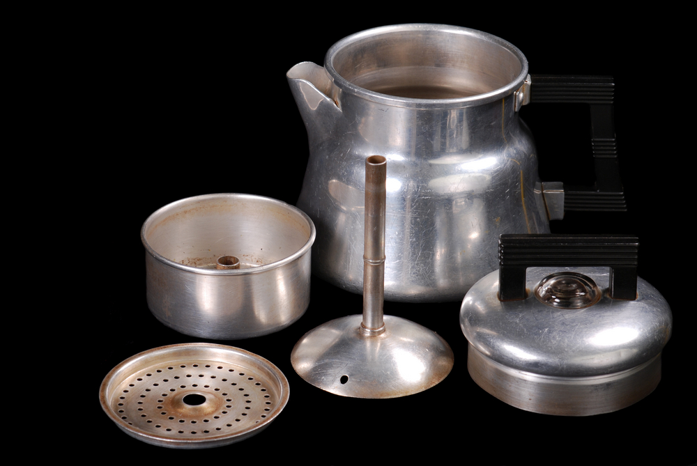Disassembled view of vintage mini percolator, black iso.