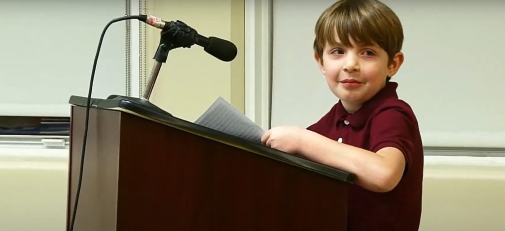 Teddy at Princeton School Board podium speaking about autism