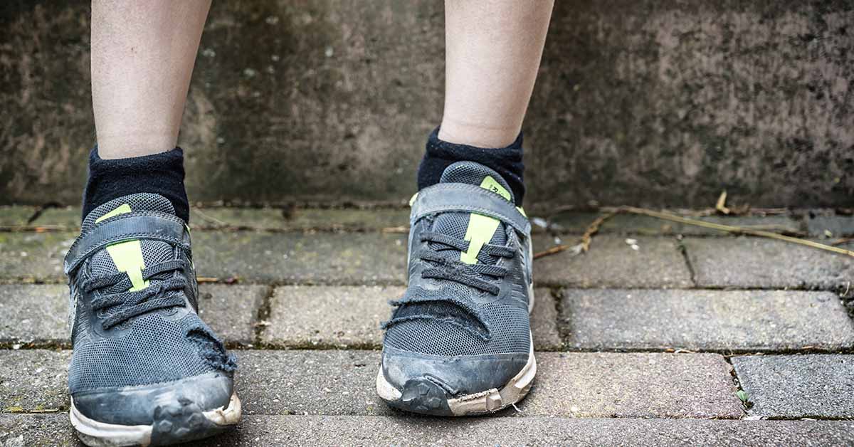 close-up of a person's feet wearing running shoes.