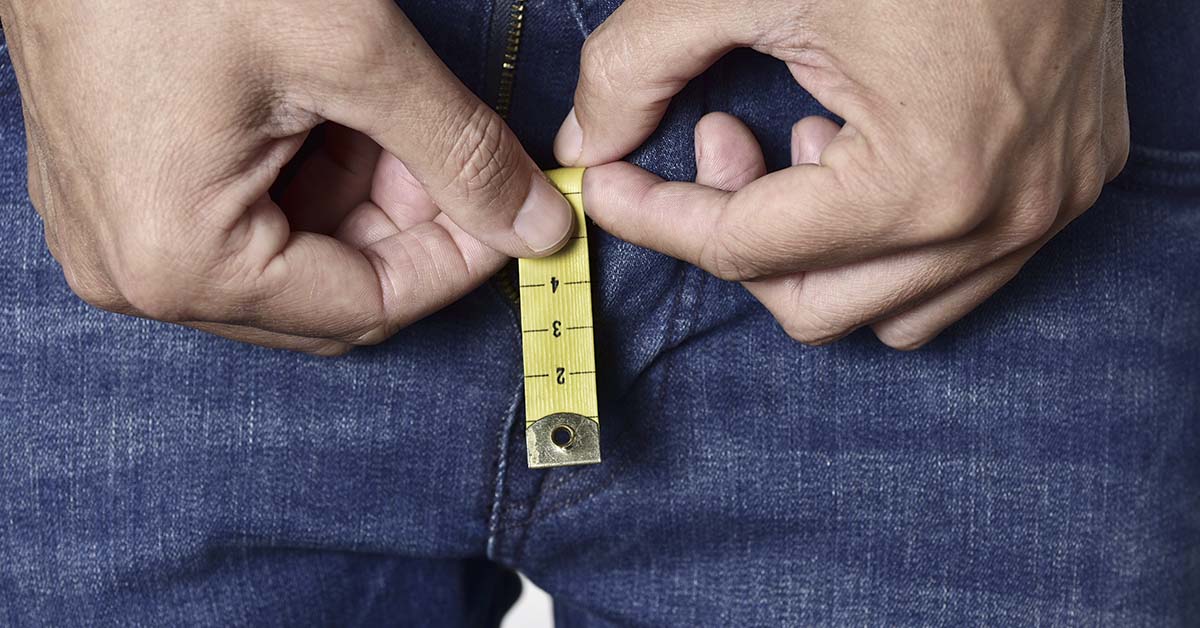 man with measuring tape near groin. Small penis, micropenis concept