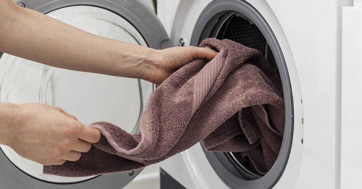 putting towels into a front load washer or dryer