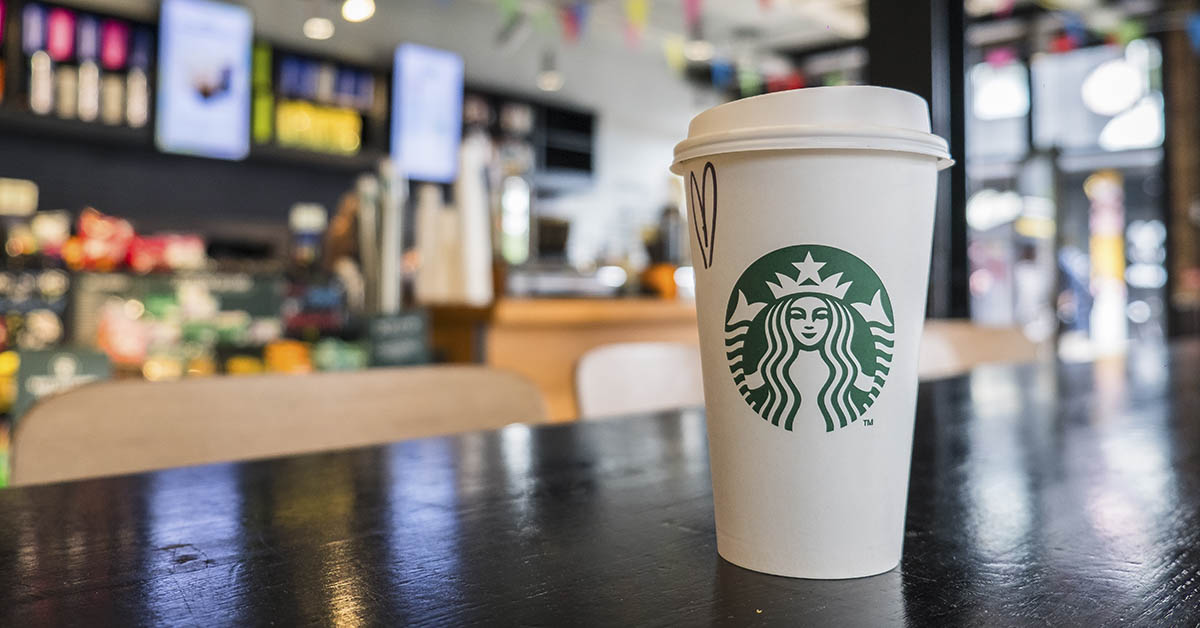 Starbucks cup on a table inside of a Starbucks