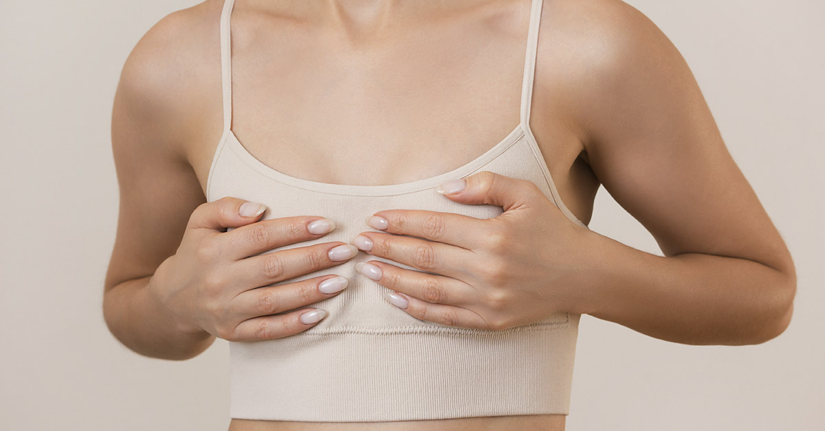 woman holding her small breasts