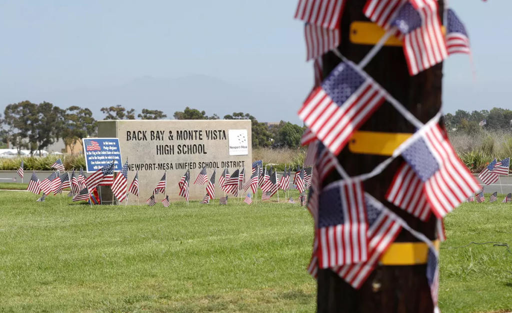 Small American flags are placed around the Back Bay and Monte Vista High School marquee sign