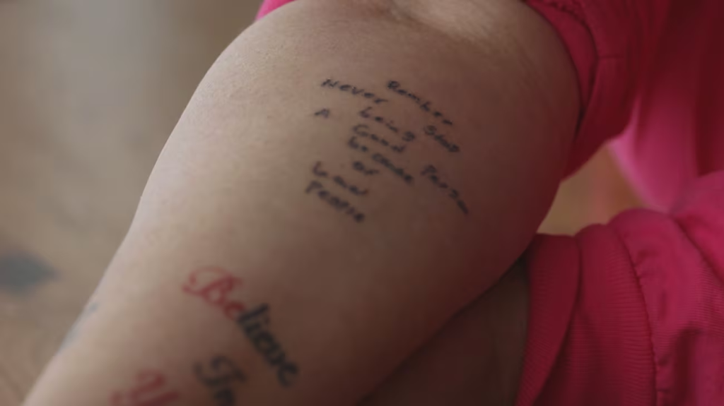 A tattoo on Shannon Heacock's arm preserves one of the final messages written by Elijah Heacock: "Remember: Never stop being a good person because of bad people."