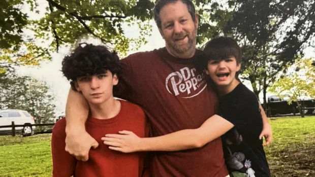 Elijah Heacock, left, and John Burnett, center, with Heacock's younger brother.