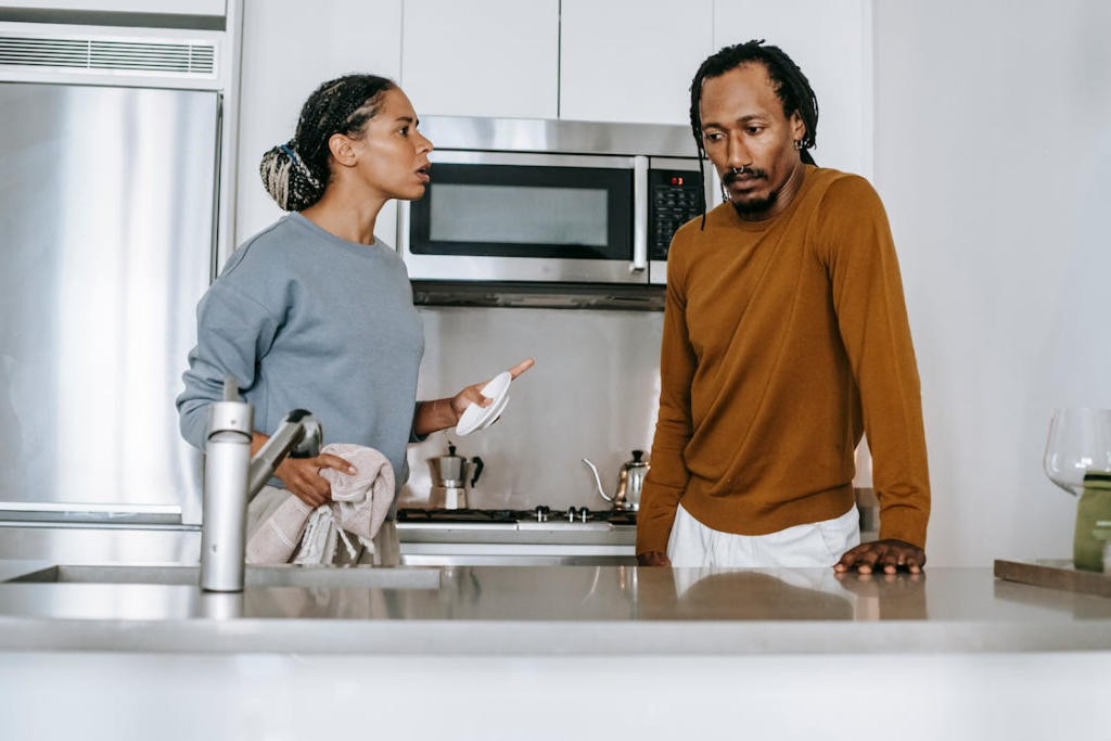 upset couple talking in kitchen