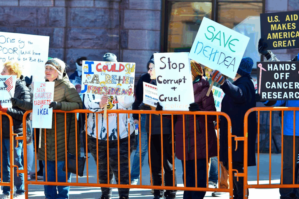 Diverse Protesters Holding Signs at Outdoor Rally
