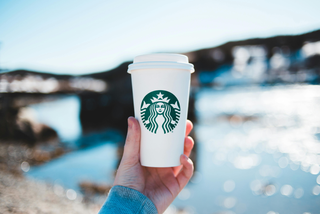 Starbucks cup against blurred waterfront background for TikTok job application story.
