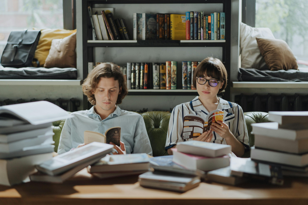 Two people reading books comfortably together, demonstrating healthy shared silence in relationships where couples who don't need to constantly talk feel connected despite separate activities.
