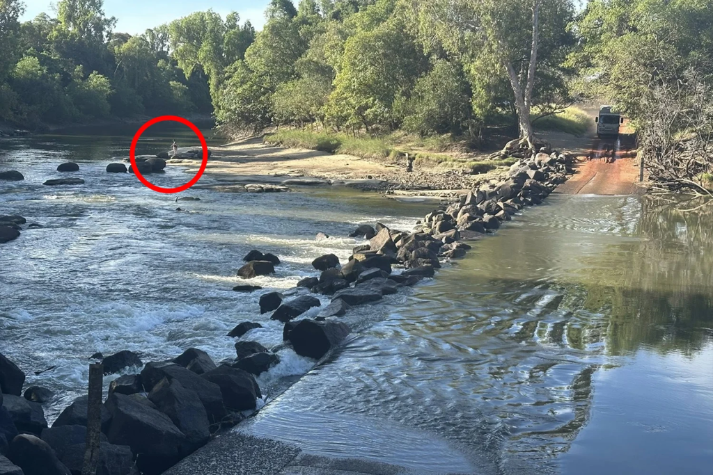 A picture showing an adult and child fishing at Cahills Crossing has sparked a fierce online debate.