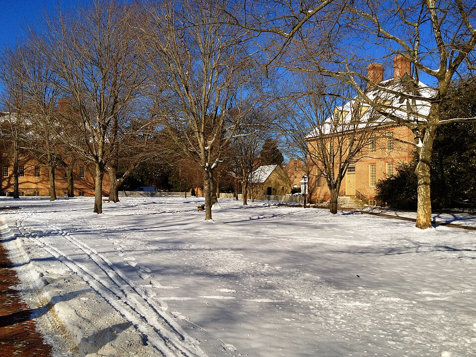 Winter snow blanketing Colonial Williamsburg's historic buildings, showcasing why underrated destinations offer magical seasonal travel experiences.