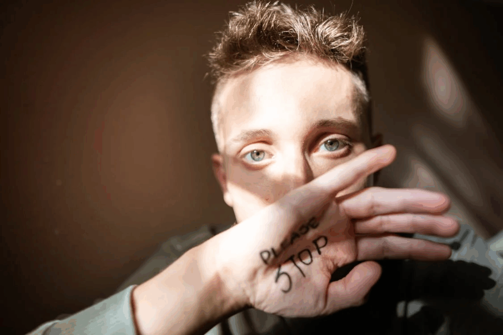 Young Man Asking for Help with Message Written on his Hand