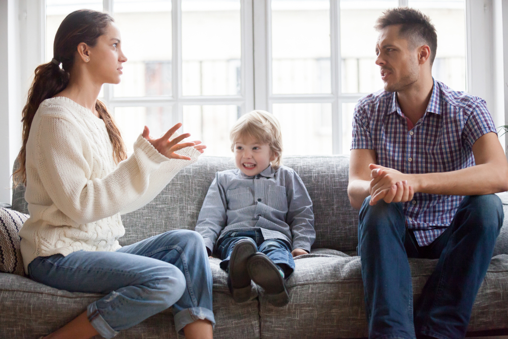 Frustrated little boy son scared with mom and dad fighting at home, sad stressed child suffers from parents argument or divorce causing mental psychological trauma, family conflicts hurt kid concept