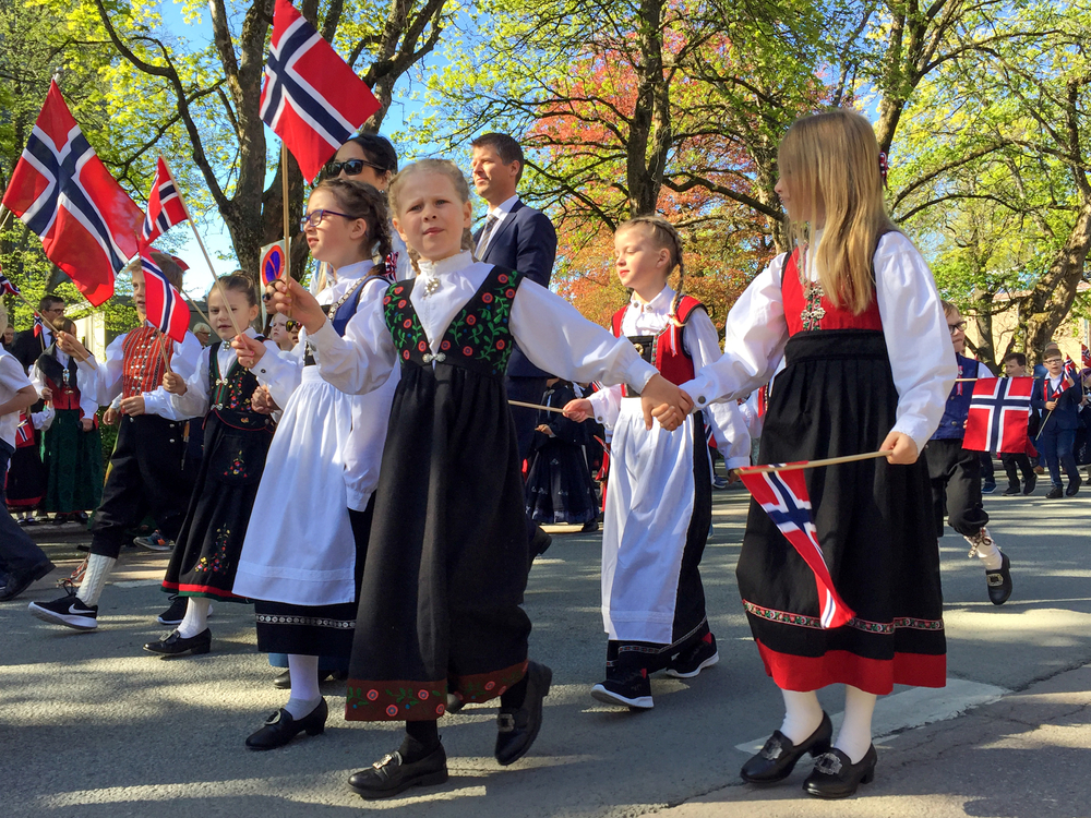 TRONDHEIM, NORWAY - MAY 17, 2019: Children parade holding Norwegian flags on Constitution Day, the national day of Norway.