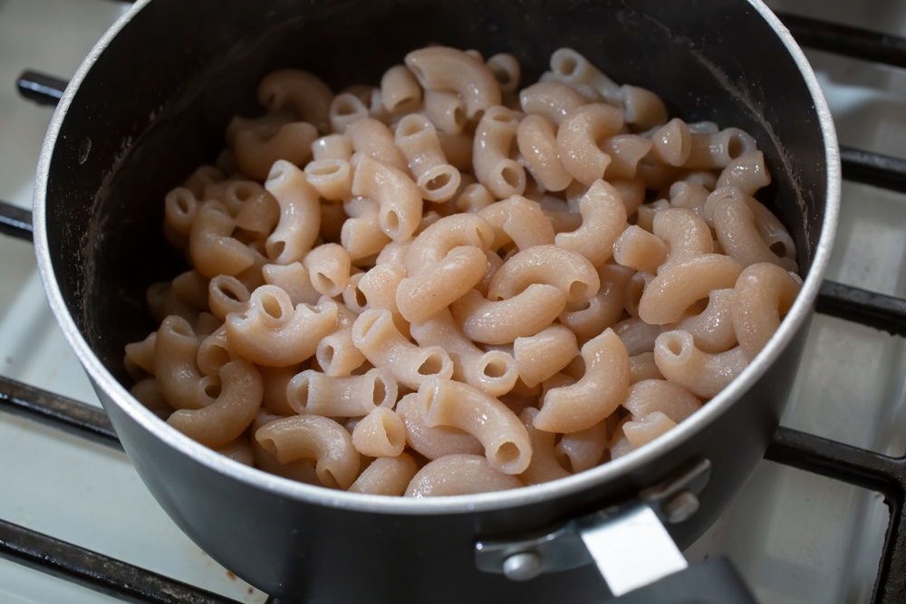 A view of cooked gluten-free macaroni pasta in a non-stick pot.