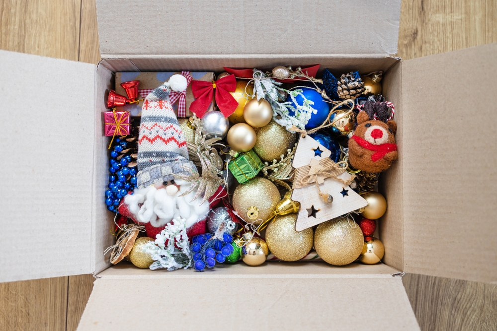 Old Christmas decorations and toys in box. Storage of Christmas tree toys. Box of many old toys.