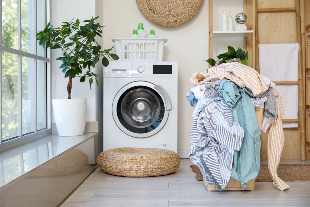 Basket full of dirty clothes in light laundry room
