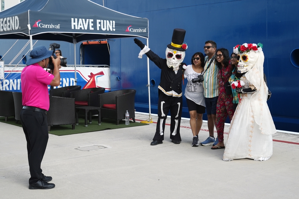 Cozumel, Mexico - December 31, 2024: A photographer from carnival cruise line take a picture of a passenger in the gangway with the local character of mexico.
