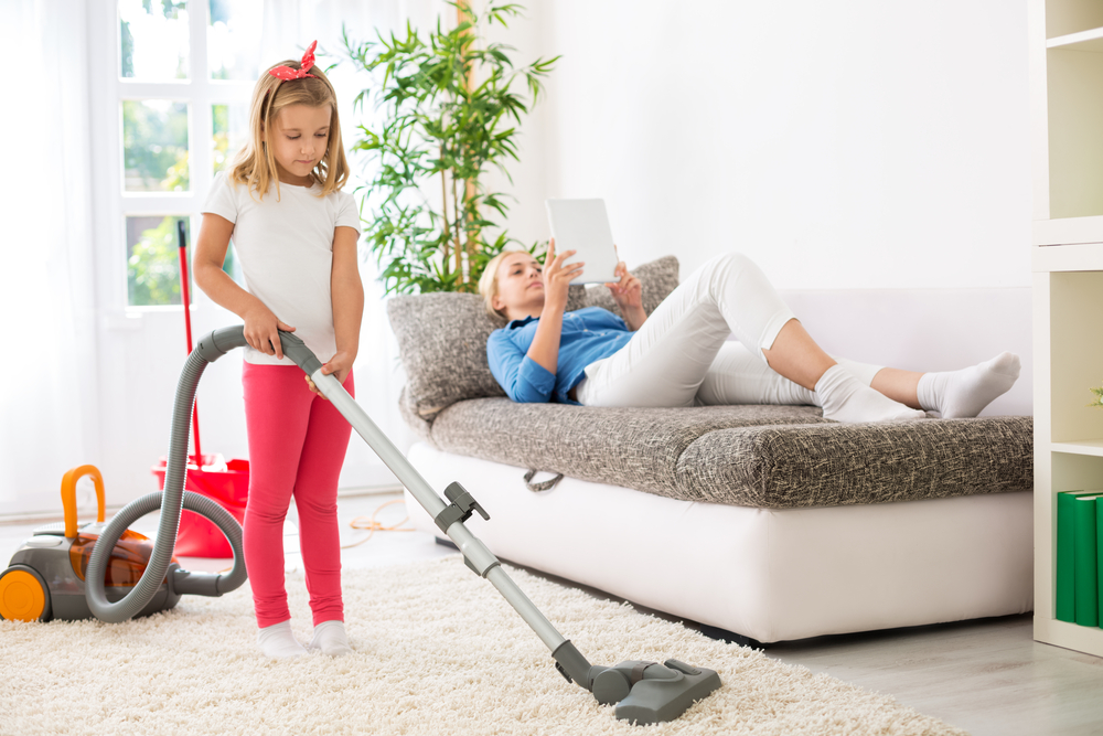 Lazy mother exploitation little child for cleaning home