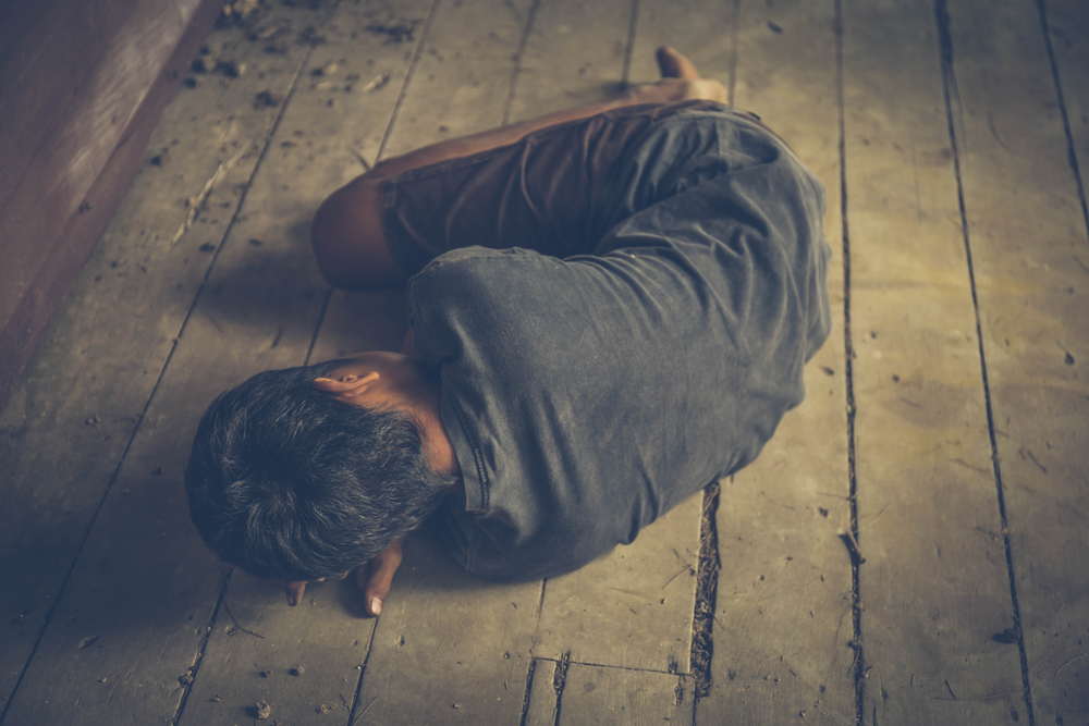 homeless or victim lay down on the floor bare foot and dirty clothes , concept for violence,homeless people,kidnapping,violence,terrified,A fearful child,Human Rights