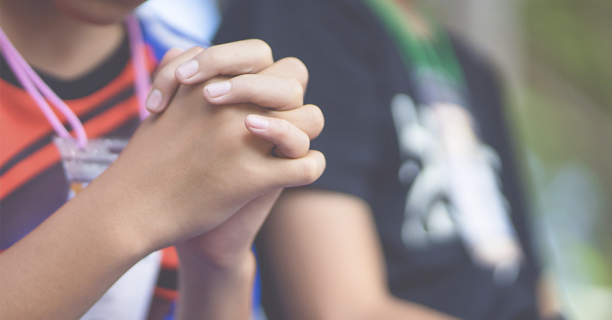 child's hands clasped together