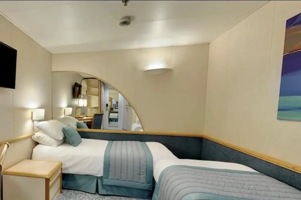 An inner villa aboard the ship complete with two separate beds and a television.