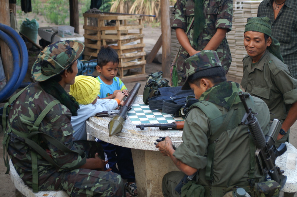Soldiers and children in a liberated area under control of the Karen National Liberaton Army (KNLA). Kawthoolei, Myanmar - 03.08.2006
