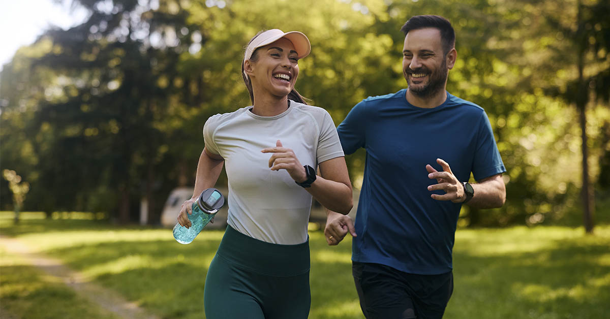 couple smiling and jogging together