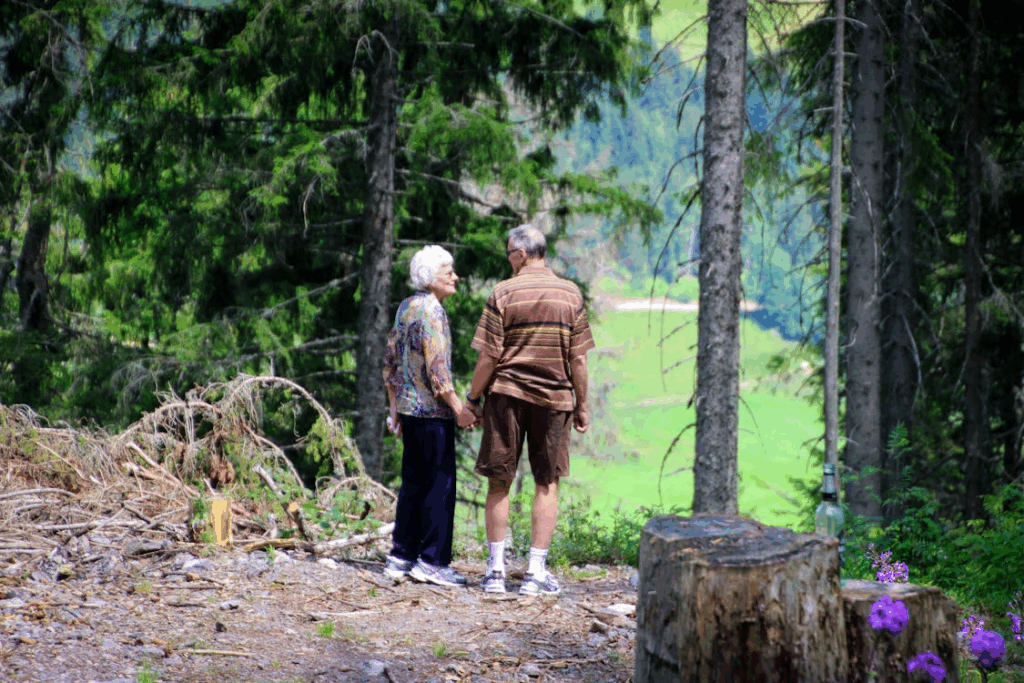 Two Elderly People Standing in Forest
