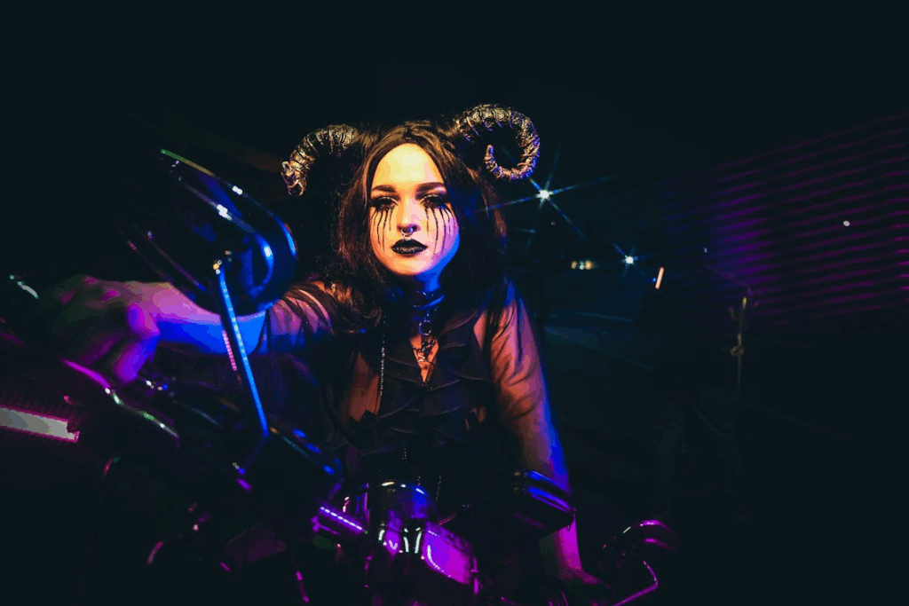 A Woman Wearing a Costume on a Motorcycle