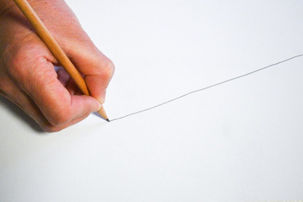 Hand drawing boundary line on paper, showing signs of protecting relationships from toxic family behavior.