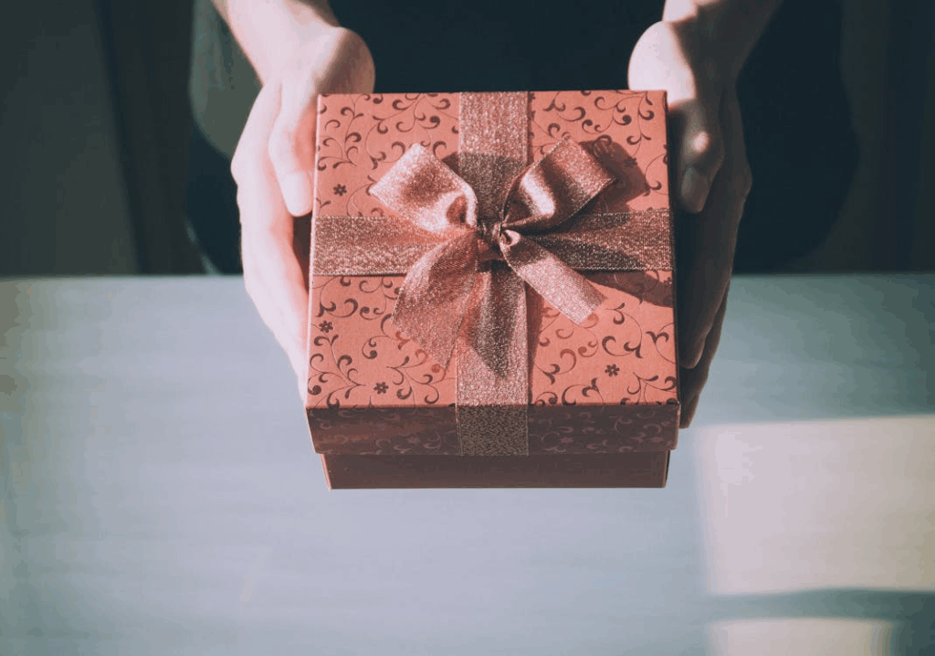 woman holding wrapped gift box