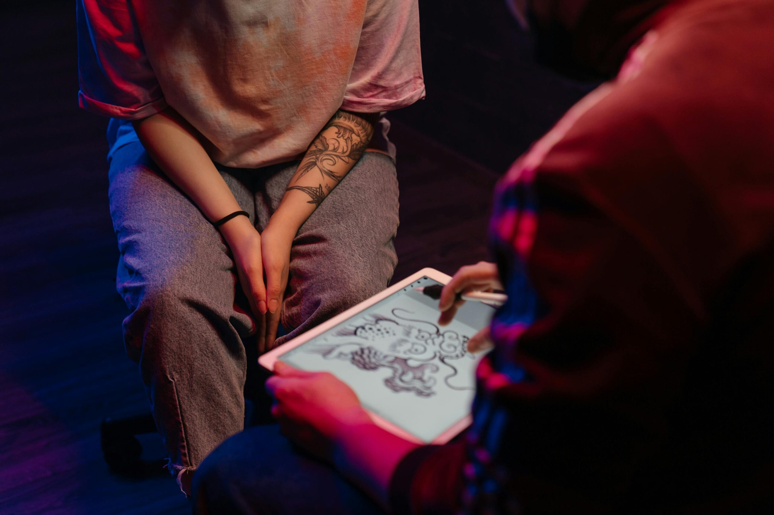 Woman consulting with tattoo artist for new design