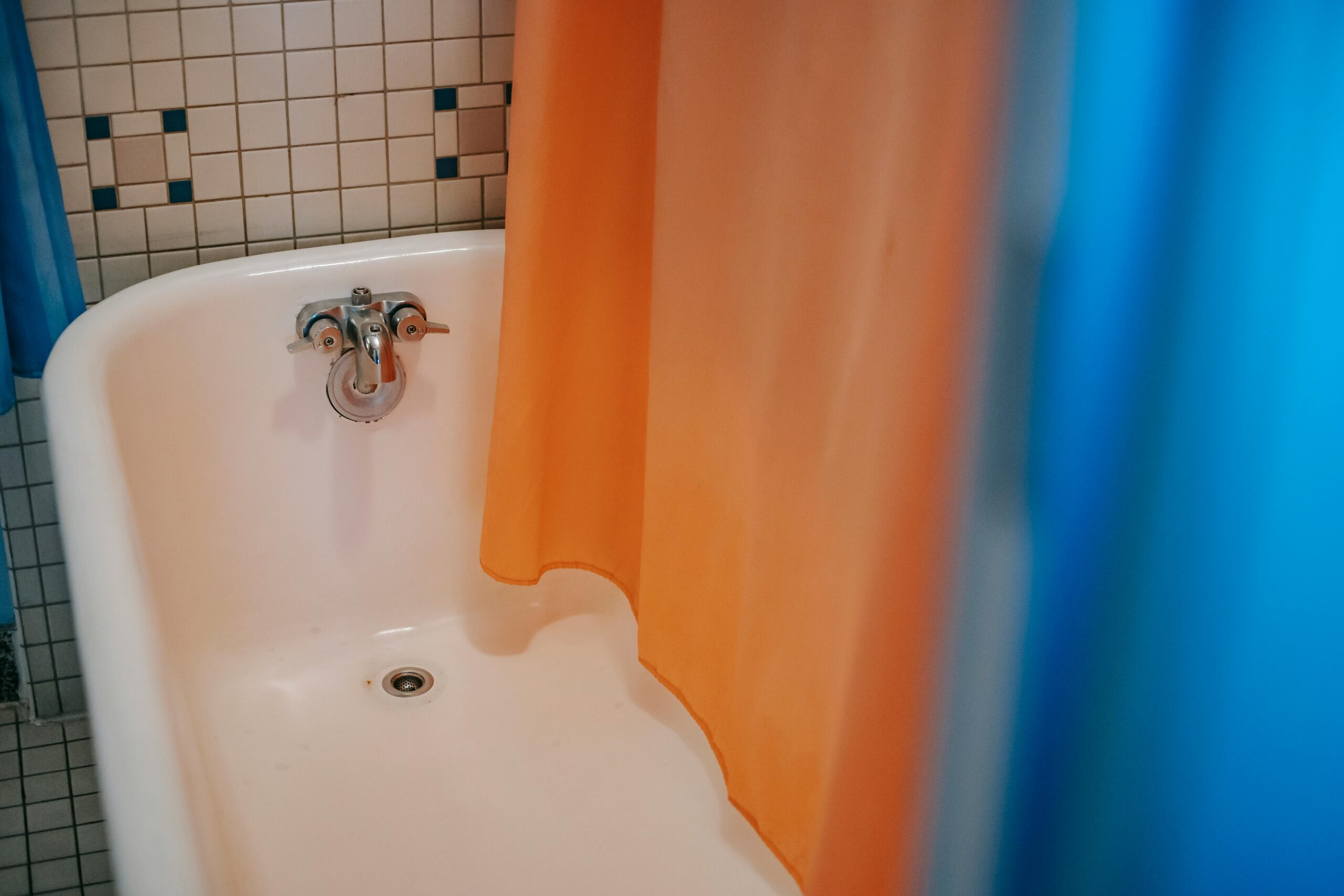 Interior of modern bathroom with colorful curtain