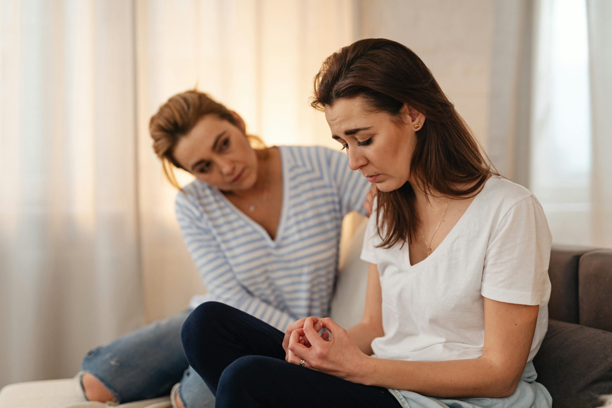 Woman showing support and comfort to another woman who is upset.