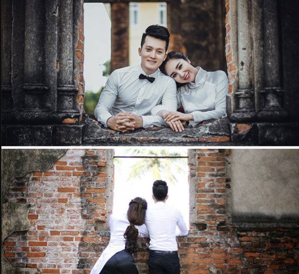 couple wearing white next to brick wall