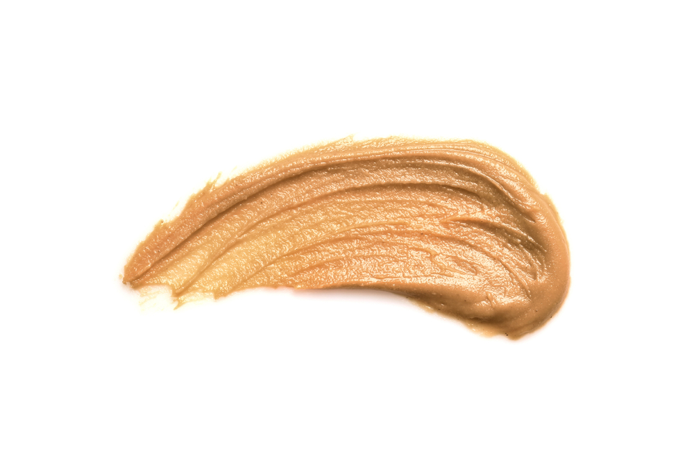 Creamy peanut butter on white background