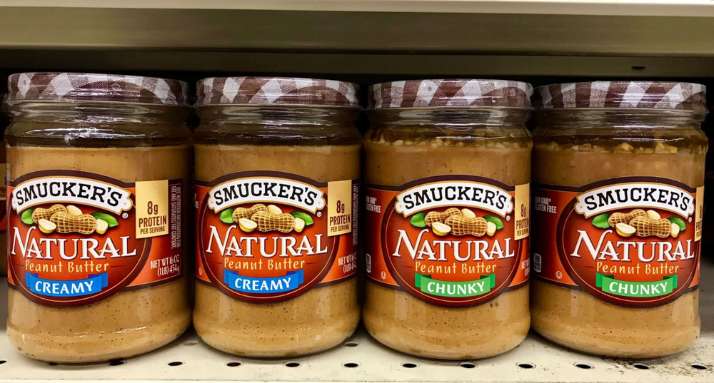 Fargo North Dakota/USA-November 03 ,2019,Several Jars of Smucker's peanut Butter products on shelve at a grocery store .