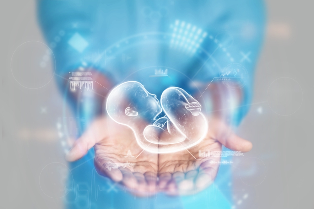 Medical concept, doctor's hands in a blue coat close-up and a hologram of a child. reproductive. Medical care, anatomy, artificial insemination. mixed media.
