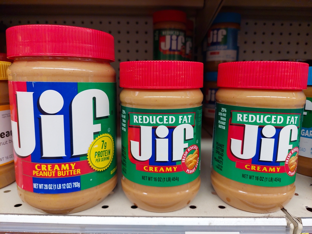 Los Angeles, California – May 9, 2024: JIF Peanut Butter Spread jars on a shelf in a supermarket. JIF is a brand of The J.M. Smucker Company
