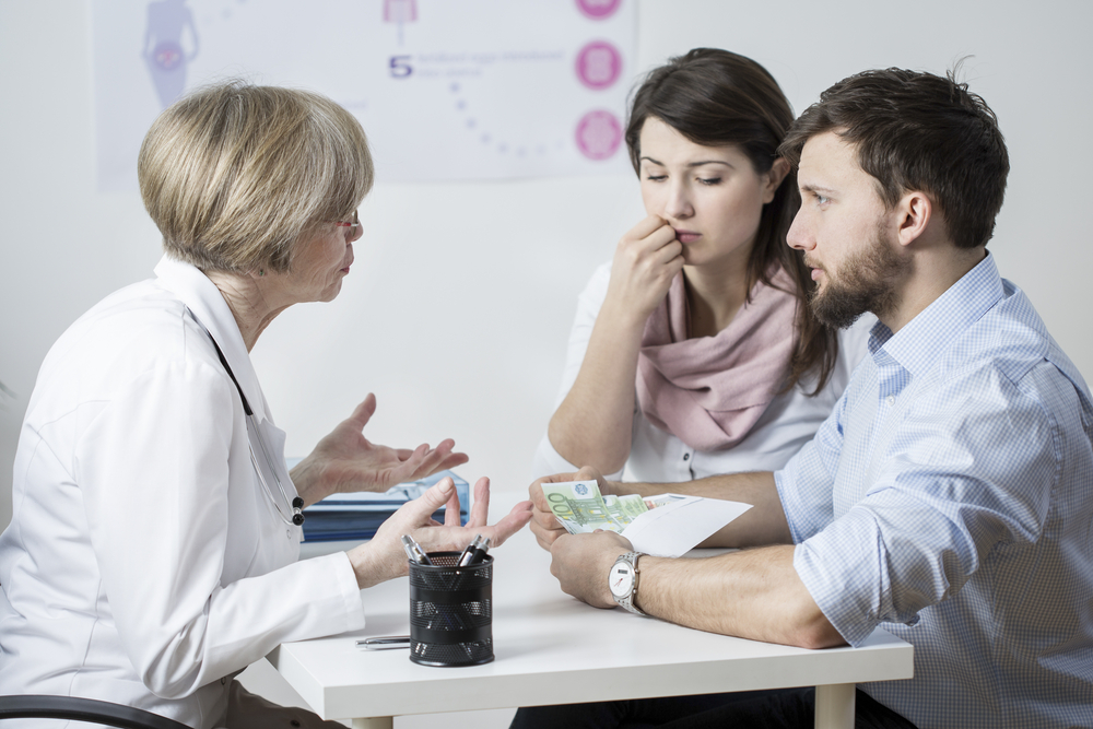 Couple giving a bribe to speed up their treatment
