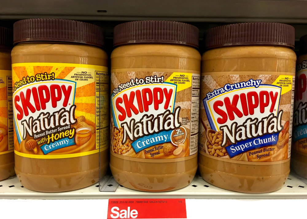 Alameda, CA - June 07, 2016: Three jars of Skippy Natural peanut butter on a grocery store shelf. Creamy, Chunky and with honey. Skippy is the 2nd most popular Peanut Butter in the world.