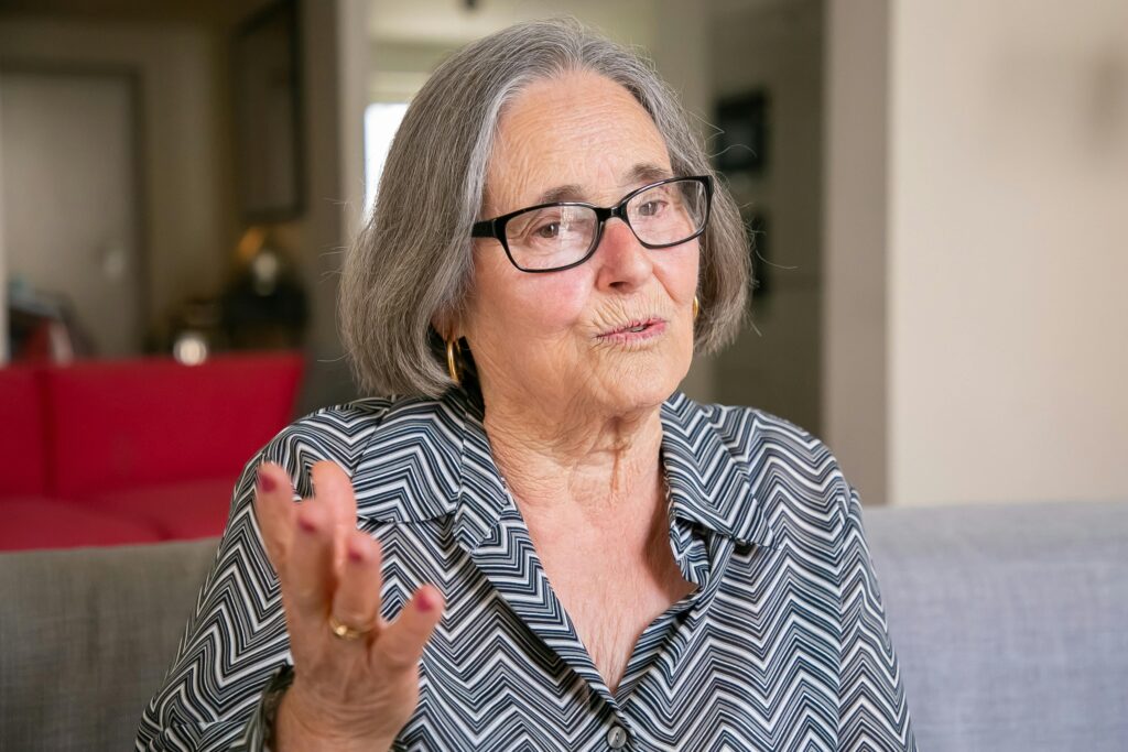 Older woman speaking, showing how early signs of dementia affect word-finding.