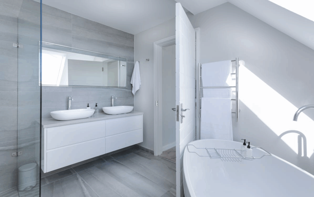 Designers are using oversized tiles to create seamless looks across walls and floors.