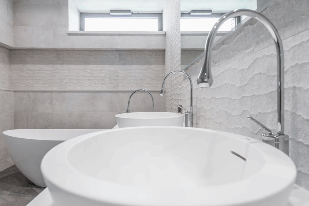 Three-dimensional tiles and panels are being used to create texture and depth on bathroom walls.